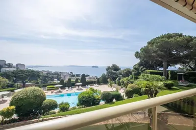 a view from the balcony of a resort with a swimming pool at Elegant 3-Room Apartment with Terrace Pool & Island Views in Cannes