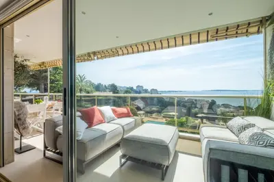 a living room with a view of the ocean at Elegant 3-Room Apartment with Terrace Pool & Island Views in Cannes