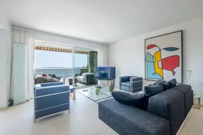 a living room with two couches and a television at Elegant 3-Room Apartment with Terrace Pool & Island Views in Cannes