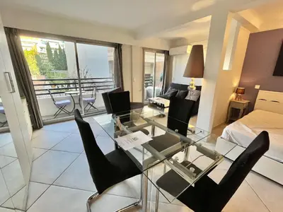 a living room with a glass table and chairs at Rouaze 2, by Welcome to Cannes in Cannes