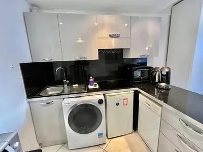 a kitchen with a washing machine and a sink at Rouaze 2, by Welcome to Cannes in Cannes