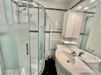 a bathroom with a glass shower and a sink at Rouaze 2, by Welcome to Cannes in Cannes