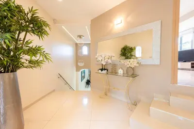 a hallway with a mirror and a plant at VILLA 330m2 heated pool and Jacuzzi in Vallauris