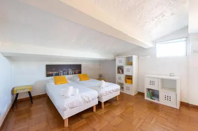 a bedroom with a large white bed and a window at VILLA 330m2 heated pool and Jacuzzi in Vallauris