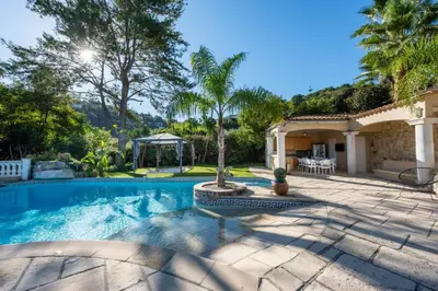 a swimming pool in a backyard with a house at VILLA 330m2 heated pool and Jacuzzi in Vallauris