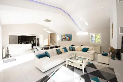 a living room with a white couch and a table at VILLA 330m2 heated pool and Jacuzzi in Vallauris