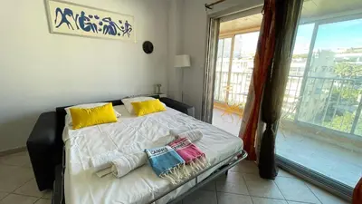 a bedroom with a bed with two pillows and a window at Cannes center - very practical - all comfort in Cannes