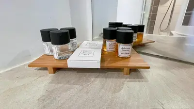 a wooden table with four bottles of cosmetics on it at Cannes center - very practical - all comfort in Cannes