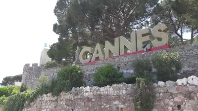 a sign on top of a stone wall at Cannes center - very practical - all comfort in Cannes