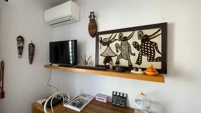 a shelf with a tv and a picture on a wall at Cannes center - very practical - all comfort in Cannes