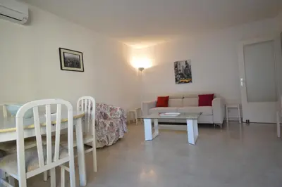 a living room with a couch and a table at Cannes studio ideal for congresses or holidays in Cannes