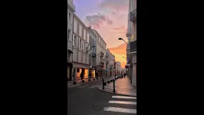 a city street with a sunset in the background at Cannes studio ideal for congresses or holidays in Cannes