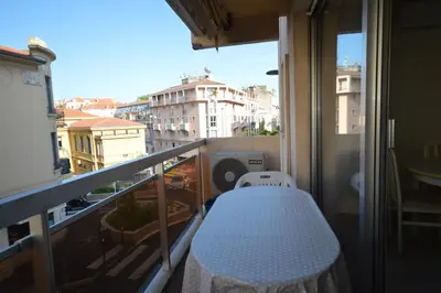 a bed on a balcony with a view of a city at Cannes studio ideal for congresses or holidays in Cannes