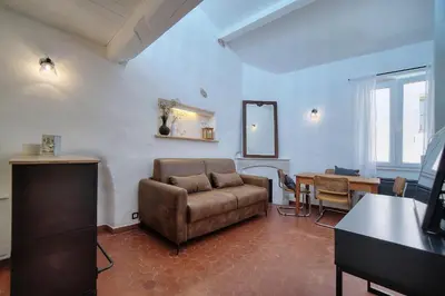 a living room with a couch and a table at IMMOGROOM - Cosy - Renovated duplex - Close to the beach in Cannes