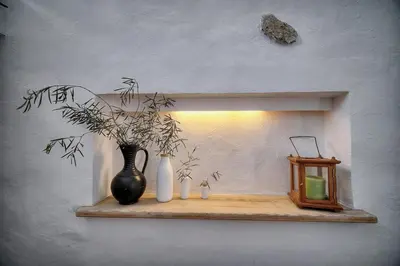 a shelf with a vase and a plant and a light at IMMOGROOM - Cosy - Renovated duplex - Close to the beach in Cannes