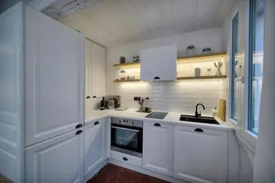 a white kitchen with white cabinets and a sink at IMMOGROOM - Cosy - Renovated duplex - Close to the beach in Cannes