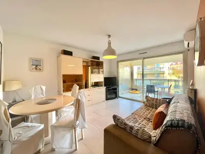 a living room with a couch and a table at Cannes center 2, by Welcome to Cannes in Cannes