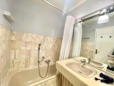 a bathroom with a sink and a bath tub at Cannes center 2, by Welcome to Cannes in Cannes