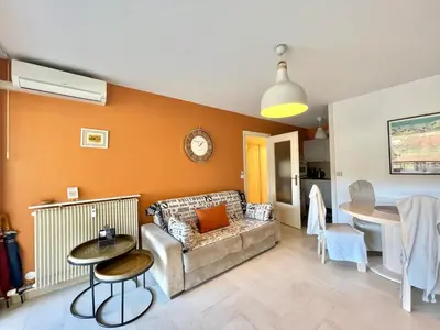 a living room with a couch and a table at Cannes center 2, by Welcome to Cannes in Cannes