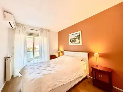 a bedroom with a large white bed and a window at Cannes center 2, by Welcome to Cannes in Cannes