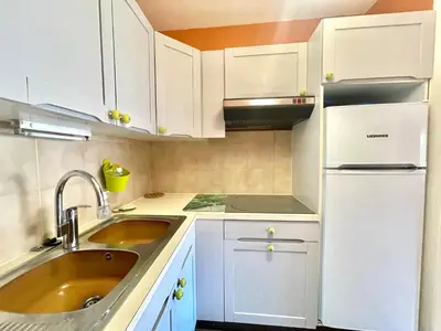 a white kitchen with a sink and a refrigerator at Cannes center 2, by Welcome to Cannes in Cannes