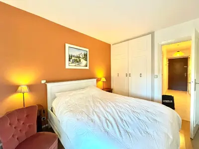 a bedroom with a white bed and a chair at Cannes center 2, by Welcome to Cannes in Cannes