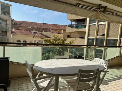 a white table and chairs on a balcony at Cannes center 2, by Welcome to Cannes in Cannes
