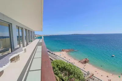 a view of the beach from a balcony of a building at Incroyable 4P Vue Mer Panoramique in Cannes