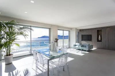 a living room with a glass table and chairs at Incroyable 4P Vue Mer Panoramique in Cannes