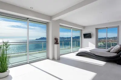 a bedroom with a view of the ocean at Incroyable 4P Vue Mer Panoramique in Cannes