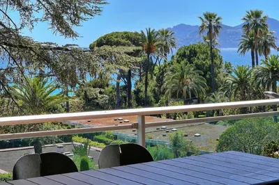 a table on a balcony with a view of the ocean at Somptueux 2 chambres vue MER, TERRASSE, PARKING A2B232 in Cannes