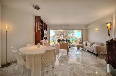 a living room with a table and a couch at Somptueux 2 chambres vue MER, TERRASSE, PARKING A2B232 in Cannes