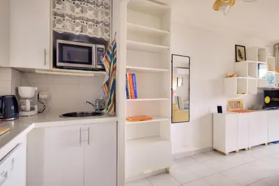 a kitchen with white cabinets and a microwave at Résidence Cannes Villa Francia - maeva Home - Appartement climatisé avec vue mer 2 pièces 4 personnes - Prestige - super Home MAE-2644 in Cannes
