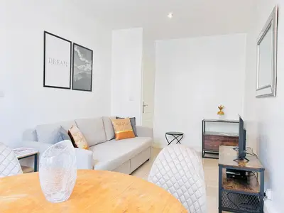a living room with a couch and a table at 2 Bedroom flat Cannes Center La Croisette Banane in Cannes