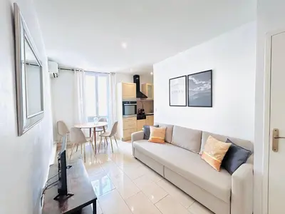 a living room with a couch and a table at 2 Bedroom flat Cannes Center La Croisette Banane in Cannes