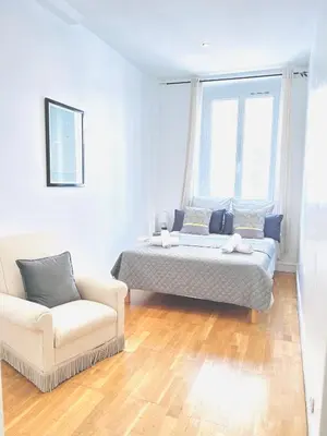 a bedroom with a bed and a couch and a chair at 2 Bedroom flat Cannes Center La Croisette Banane in Cannes