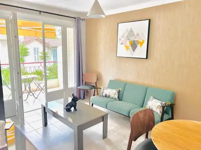 a living room with a couch and a table at 2 bedroom luxury flat with Balcony Cannes Center in Cannes
