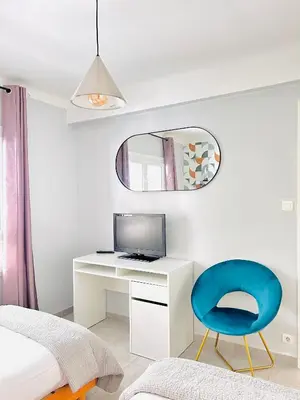 a bedroom with a desk and a blue chair at 2 bedroom luxury flat with Balcony Cannes Center in Cannes