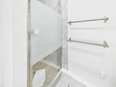 a bathroom with a shower with a glass door at LE SPECTACULAIRE moderne et raffiné, idéalement situé à deux pas du Palais et plages in Cannes
