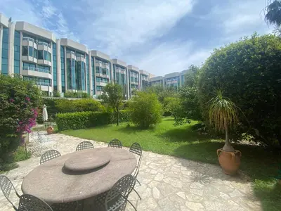 a patio with a table and chairs and a building at Viva Riviera Unique Apartment with Terrace and Secret Garden Croisette in Cannes