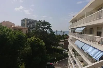 a balcony of a building with a motorcycle parked next to it at Spacious 70 m flat with Balcony and sea view! in Cannes