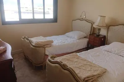 a bedroom with two beds and a window at Spacious 70 m flat with Balcony and sea view! in Cannes