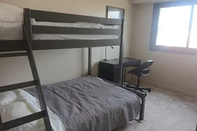 a bedroom with two bunk beds and a desk at Spacious 70 m flat with Balcony and sea view! in Cannes