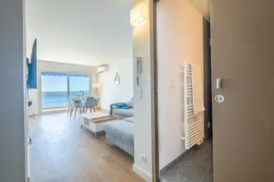 a living room with a view of the ocean at RARE! 2-Br Seafront Apartment in Cannes
