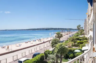a view of the beach from the balcony of a building at RARE! 2-Br Seafront Apartment in Cannes