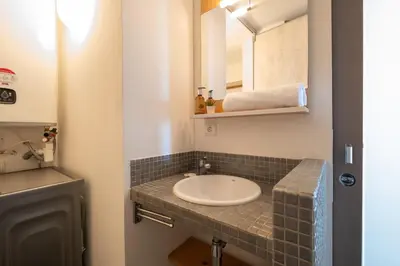 a bathroom with a sink and a mirror at RARE! 2-Br Seafront Apartment in Cannes