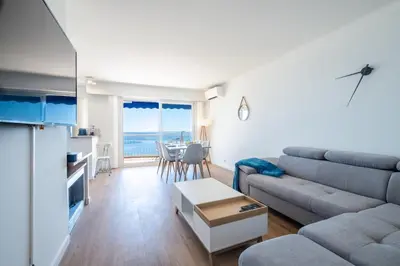a living room with a couch and a table at RARE! 2-Br Seafront Apartment in Cannes