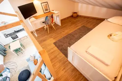 an overhead view of a room with a bed and a desk at Montgolfiere Apartment by Connexion in Cannes