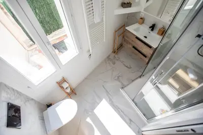 a kitchen and dining room with a table and chairs at Montgolfiere Apartment by Connexion in Cannes