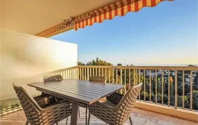 a table and chairs on a balcony with the ocean at 1 Bedroom Gorgeous Apartment In Cannes in Cannes